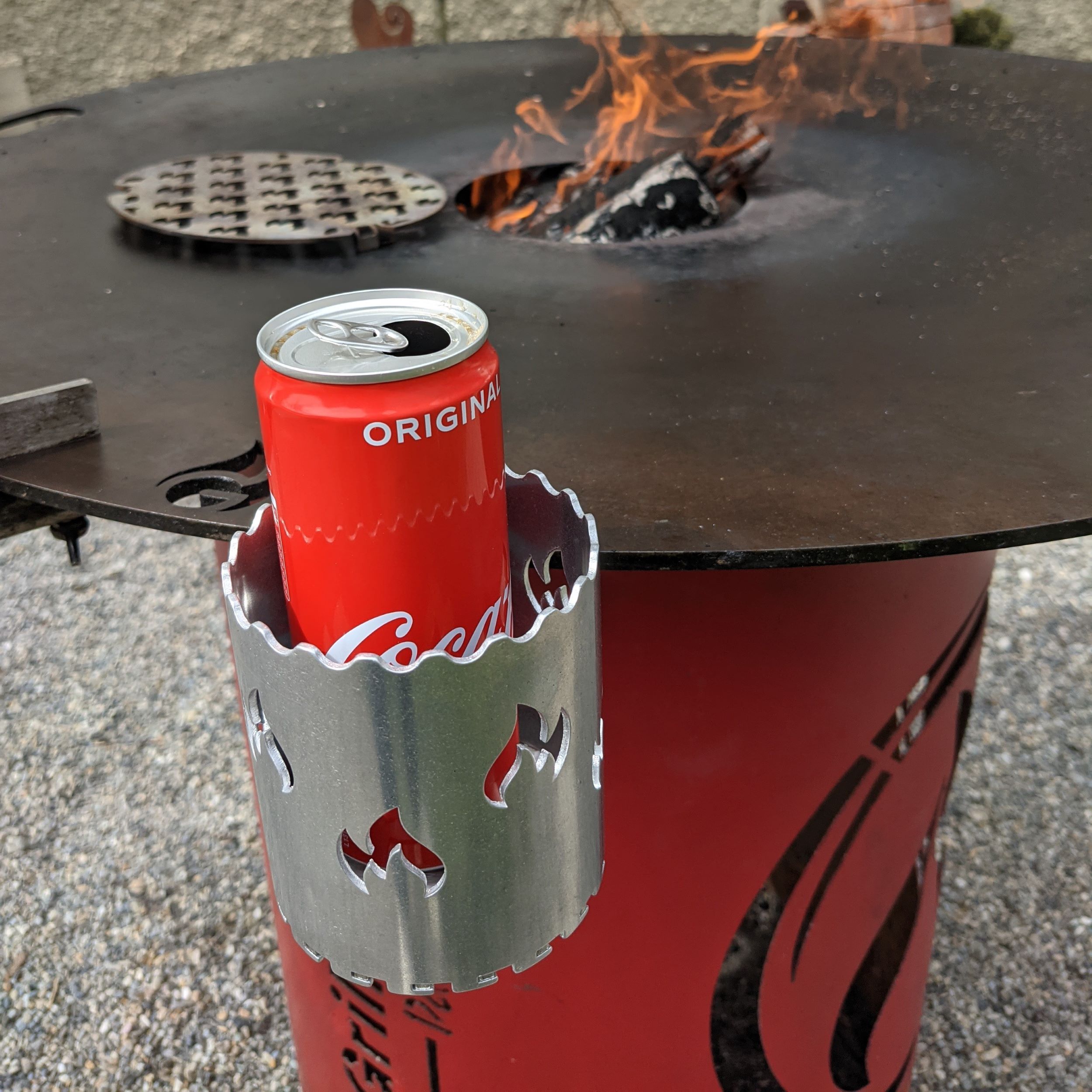 Bottle holder for the fire plate with integrated bottle opener